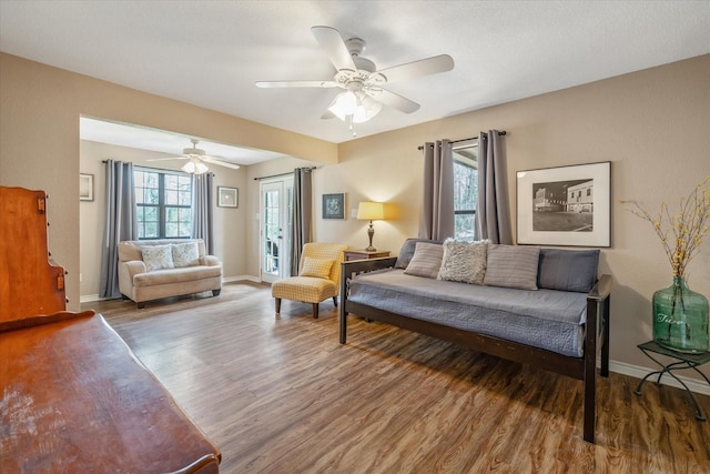 736 Wildwood Trl, Holly Lake Ranch, TX 75765 - living room featuring wood finished floors, ceiling fan, and baseboards