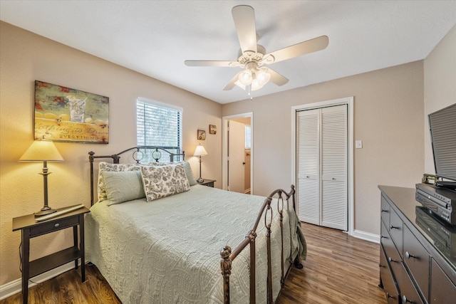 736 Wildwood Trl, Holly Lake Ranch, TX 75765 - bedroom featuring wood finished floors, baseboards, a closet, and a ceiling fan