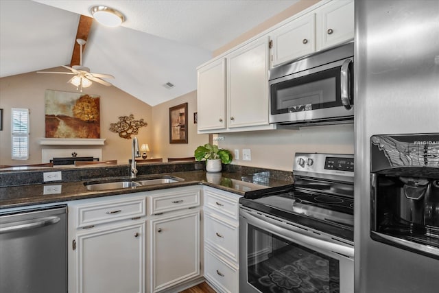 736 Wildwood Trl, Holly Lake Ranch, TX 75765 - kitchen with stainless steel appliances, a sink, ceiling fan, white cabinetry, and lofted ceiling