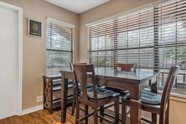 736 Wildwood Trl, Holly Lake Ranch, TX 75765 - dining area with a textured wall, wood finished floors, and baseboards