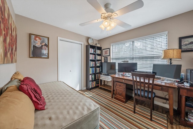 736 Wildwood Trl, Holly Lake Ranch, TX 75765 - bedroom featuring an office area, wood finished floors, a closet, and a ceiling fan