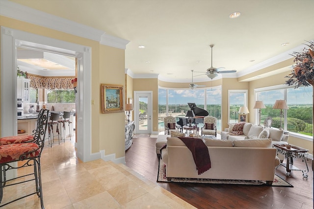 living room featuring recessed lighting, baseboards, a ceiling fan, and ornamental molding