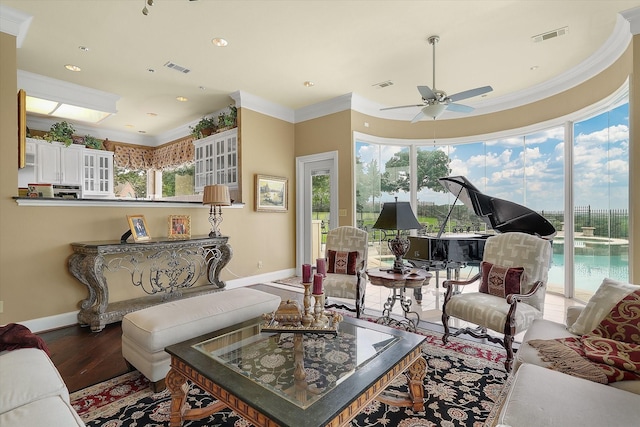 living room with visible vents, ceiling fan, and crown molding