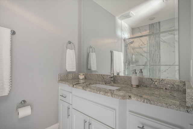 full bath with vanity, visible vents, and a marble finish shower