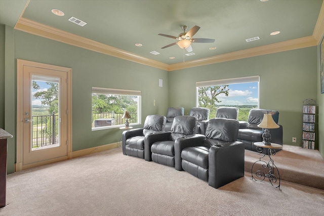 cinema room with a ceiling fan, visible vents, and ornamental molding