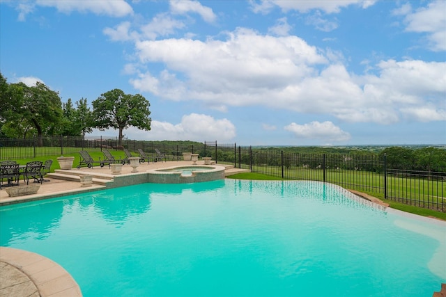 view of pool featuring a patio, a yard, fence, and a pool with connected hot tub