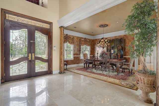 dining room featuring baseboards, a high ceiling, ornamental molding, french doors, and a chandelier