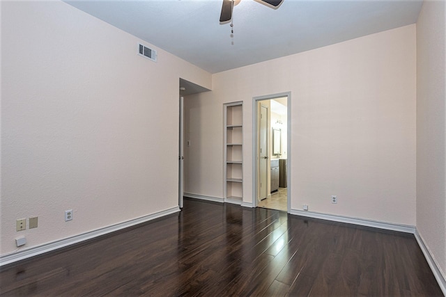8600 Coppertowne Ln Unit 303C, Dallas, TX 75243 - spare room with wood finished floors, built in shelves, ceiling fan, and baseboards