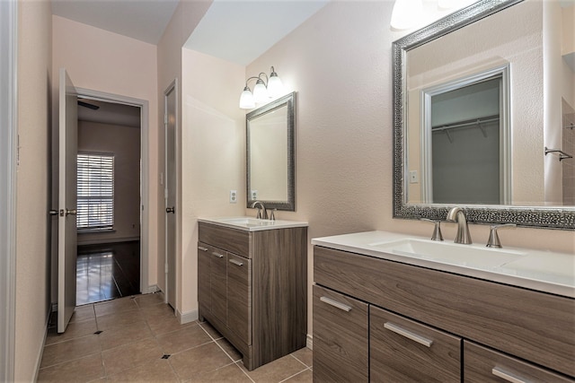 8600 Coppertowne Ln Unit 303C, Dallas, TX 75243 - full bathroom featuring two vanities and tile patterned flooring
