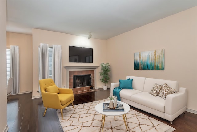 8600 Coppertowne Ln Unit 303C, Dallas, TX 75243 - living area with a tile fireplace, wood finished floors, and baseboards