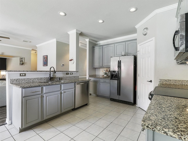 2905 Cabot Ln, Mckinney, TX 75072 - kitchen with stainless steel appliances, gray cabinetry, crown molding, a sink, and light tile patterned floors