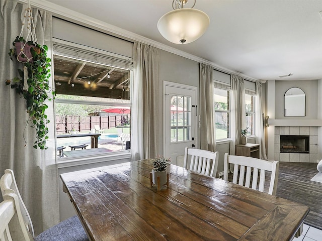 2905 Cabot Ln, Mckinney, TX 75072 - dining space with healthy amount of natural light and a tiled fireplace