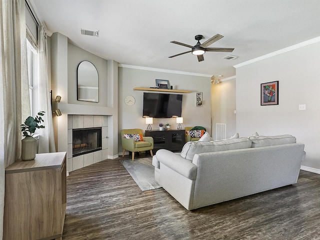 2905 Cabot Ln, Mckinney, TX 75072 - living area featuring a fireplace, dark wood-style flooring, a ceiling fan, ornamental molding, and baseboards