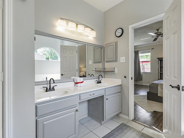 2905 Cabot Ln, Mckinney, TX 75072 - bathroom featuring connected bathroom, double vanity, tile patterned flooring, a ceiling fan, and baseboards