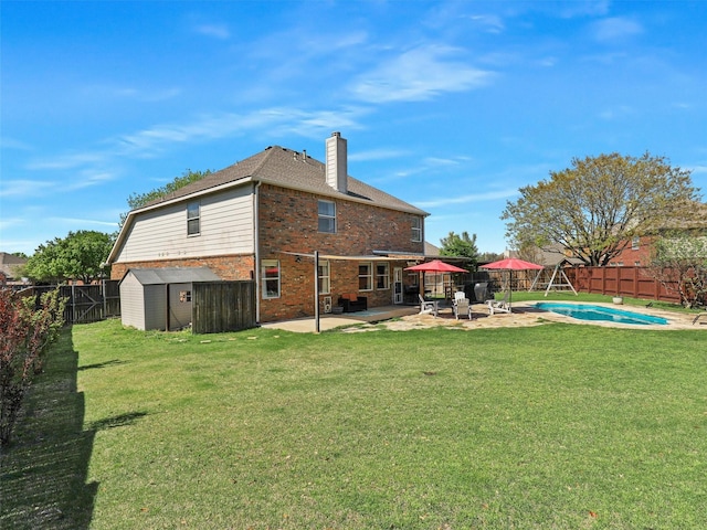 2905 Cabot Ln, Mckinney, TX 75072 - rear view of house featuring brick siding, a chimney, and a patio area