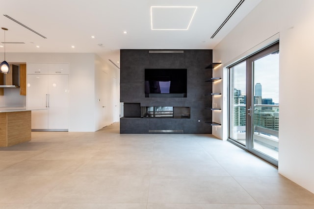 2300 Wolf St Unit 15C, Dallas, TX 75201 - unfurnished living room featuring recessed lighting and a multi sided fireplace