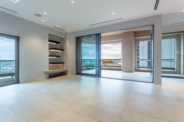 2300 Wolf St Unit 15C, Dallas, TX 75201 - unfurnished room featuring tile patterned floors and recessed lighting