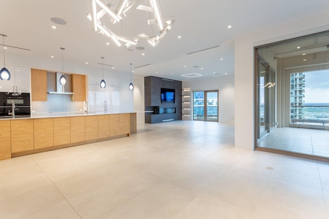2300 Wolf St Unit 15C, Dallas, TX 75201 - kitchen featuring open floor plan, modern cabinets, wall chimney range hood, and a sink