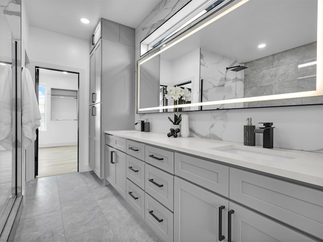 310 Harborview Dr, Rockwall, TX 75032 - full bathroom with double vanity, walk in shower, recessed lighting, and marble look tiles