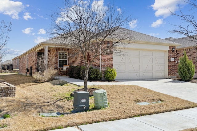 single story home featuring brick siding, driveway, and a garage