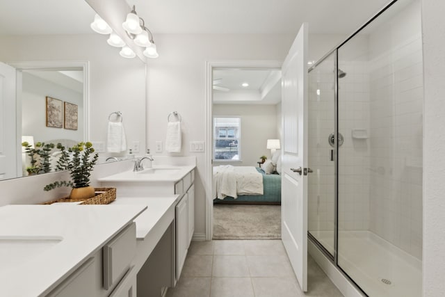 ensuite bathroom with a sink, connected bathroom, and a stall shower