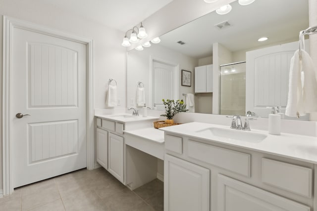 bathroom featuring tile patterned flooring, a sink, and visible vents