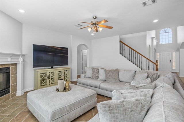 1124 Ginger Trl, Desoto, TX 75115 - living room with ceiling fan, arched walkways, recessed lighting, a tile fireplace, and visible vents