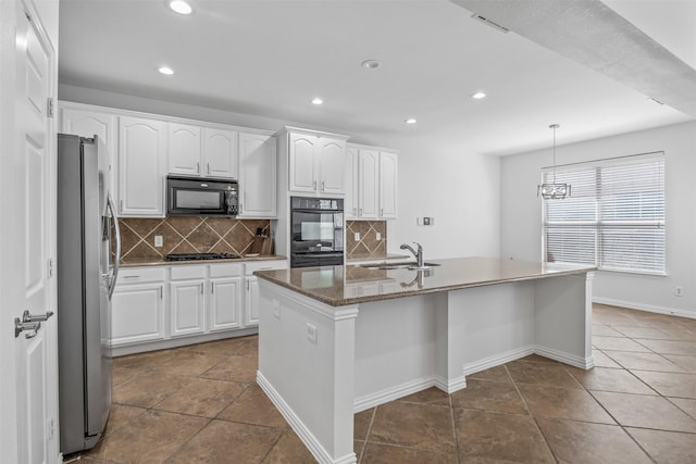 1124 Ginger Trl, Desoto, TX 75115 - kitchen featuring decorative backsplash, an island with sink, recessed lighting, white cabinetry, and black appliances