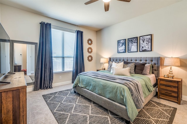 carpeted bedroom featuring baseboards and a ceiling fan