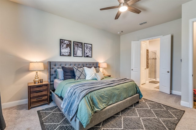 bedroom with visible vents, baseboards, ensuite bathroom, and carpet