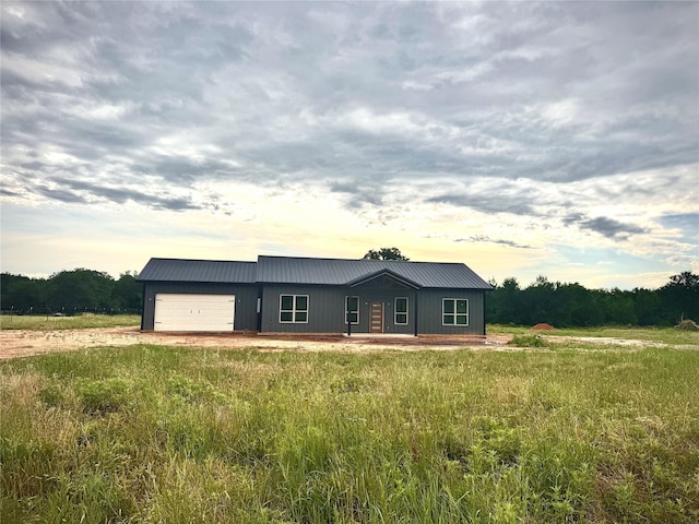 TBD5 Cowley Rd, Whitt, TX 76486 - view of front facade with dirt driveway, a garage, and a metal roof