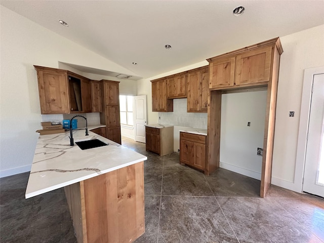 TBD5 Cowley Rd, Whitt, TX 76486 - kitchen featuring lofted ceiling, decorative backsplash, brown cabinetry, and a peninsula