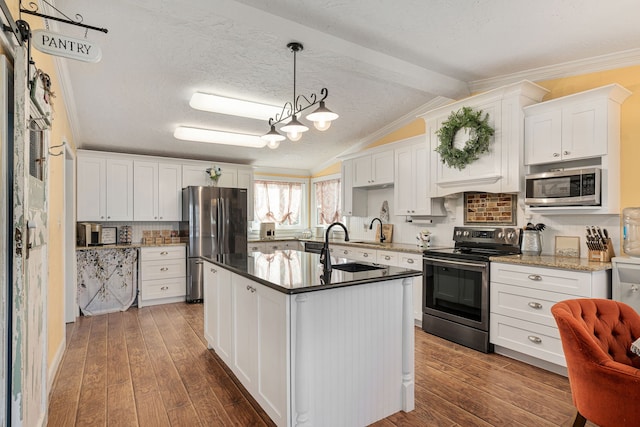 kitchen featuring a sink, vaulted ceiling with beams, dark wood-style floors, and stainless steel appliances