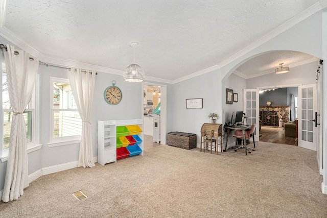 playroom featuring arched walkways, carpet flooring, and crown molding