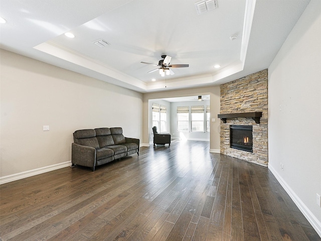 1722 Port Royal Ln, Frisco, TX 75036 - living room with a raised ceiling, a ceiling fan, dark wood-style floors, a stone fireplace, and recessed lighting