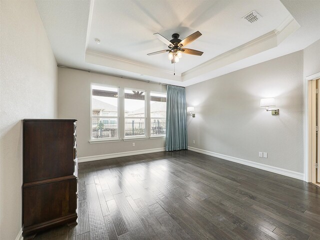 1722 Port Royal Ln, Frisco, TX 75036 - empty room featuring a tray ceiling, ornamental molding, a ceiling fan, dark wood-style flooring, and baseboards