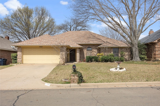 ranch-style home featuring brick siding, a garage, a front lawn, and driveway