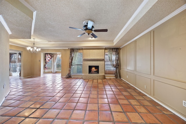 unfurnished living room with a tray ceiling, a healthy amount of sunlight, and a decorative wall