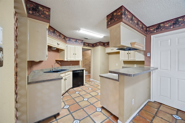 kitchen featuring a sink, black dishwasher, a peninsula, and a textured ceiling