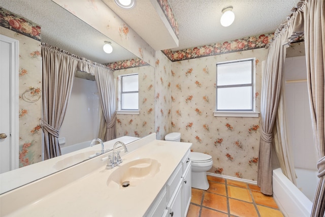 full bathroom featuring wallpapered walls, toilet, vanity, and a textured ceiling
