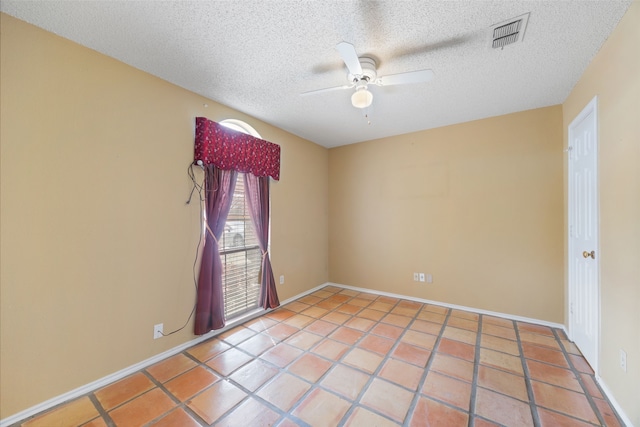 spare room with visible vents, baseboards, a textured ceiling, and ceiling fan