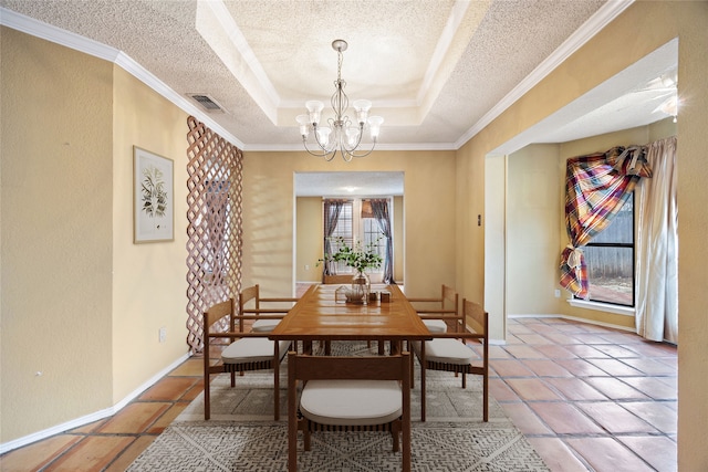dining space with visible vents, baseboards, an inviting chandelier, a textured ceiling, and a raised ceiling