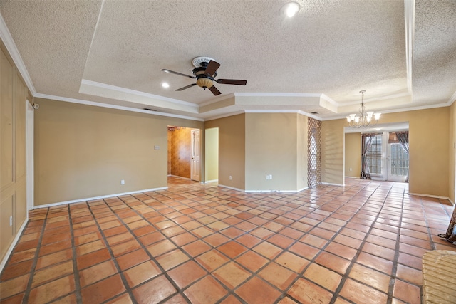 empty room with a tray ceiling, ceiling fan with notable chandelier, crown molding, and tile patterned flooring