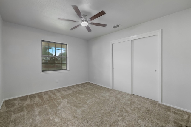 1318 Westpark Dr, Garland, TX 75040 - unfurnished bedroom with carpet floors, a closet, baseboards, and a ceiling fan