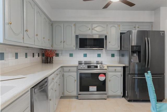 1318 Westpark Dr, Garland, TX 75040 - kitchen with appliances with stainless steel finishes, ceiling fan, light countertops, and decorative backsplash