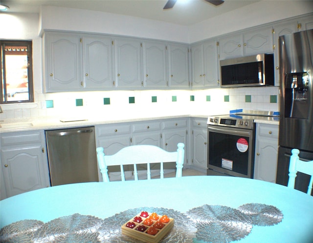 1318 Westpark Dr, Garland, TX 75040 - kitchen with stainless steel appliances, tasteful backsplash, ceiling fan, a sink, and light countertops