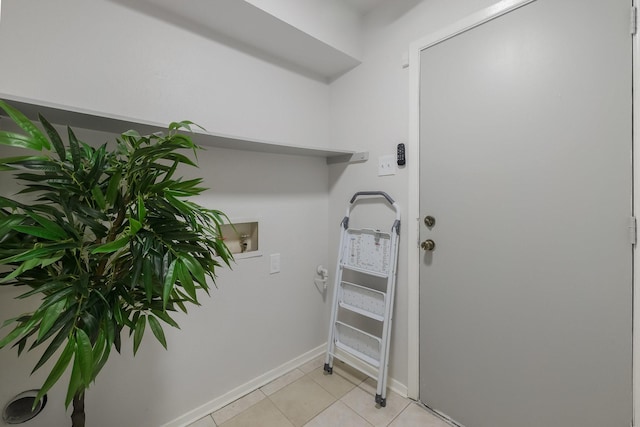 1318 Westpark Dr, Garland, TX 75040 - laundry area with washer hookup, baseboards, and light tile patterned floors