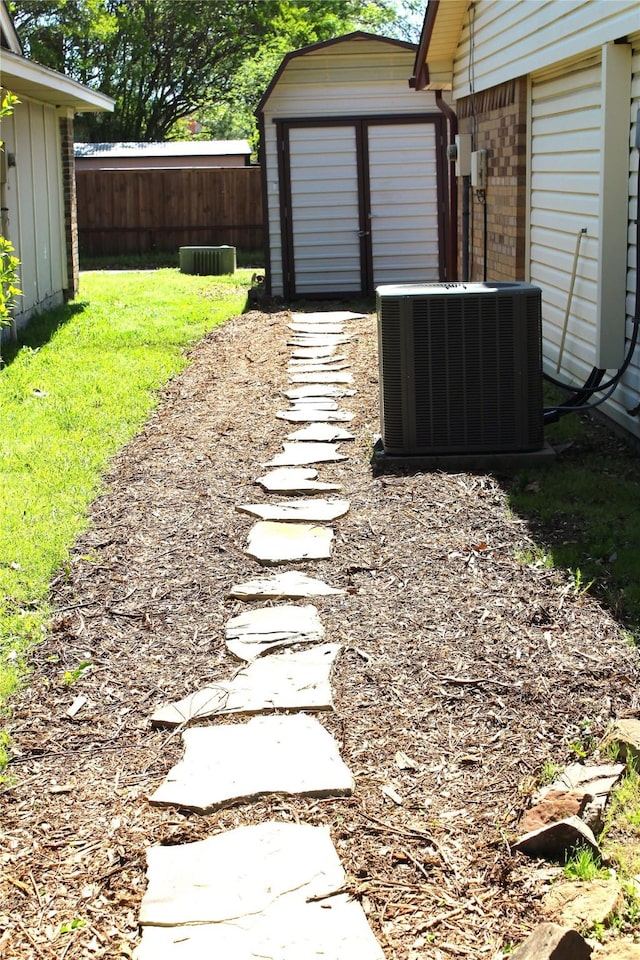 1318 Westpark Dr, Garland, TX 75040 - view of yard with central air condition unit, a shed, and an outdoor structure