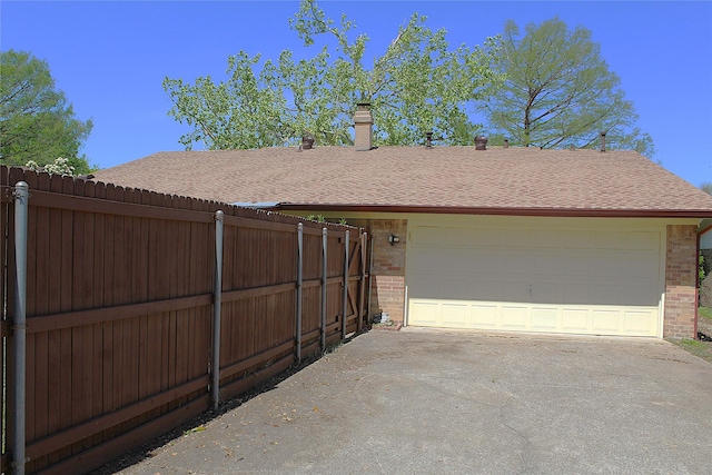 1318 Westpark Dr, Garland, TX 75040 - view of property exterior featuring brick siding, fence, a garage, and a shingled roof