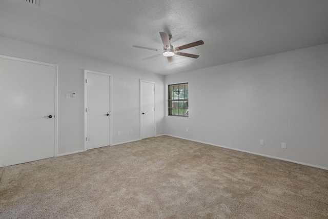 1318 Westpark Dr, Garland, TX 75040 - unfurnished bedroom with carpet floors, multiple closets, a ceiling fan, and baseboards